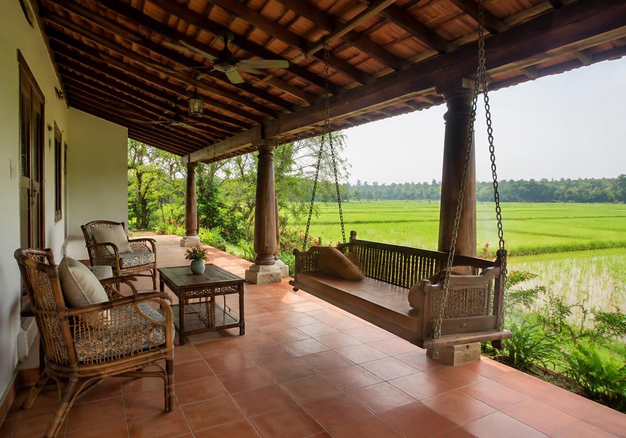 Farmhouse verandah with teak swing overlooking green fields